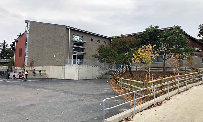 a gray brick building with a ramp