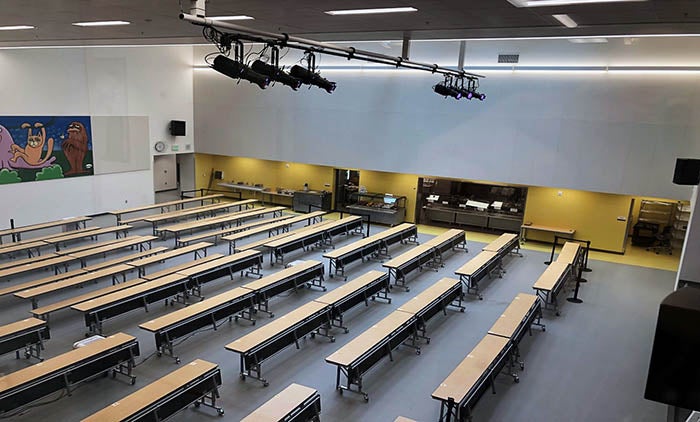 a lunchroom with the servery area and stage lighting
