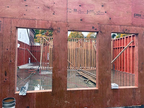 a wood wall with windows cut out