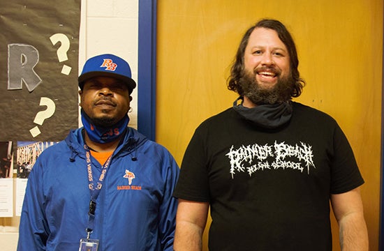 Hiller and Daniels pose for a photo in a school hallway