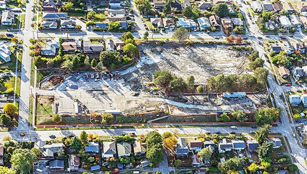 aerial view of a construction site within a neighborhood