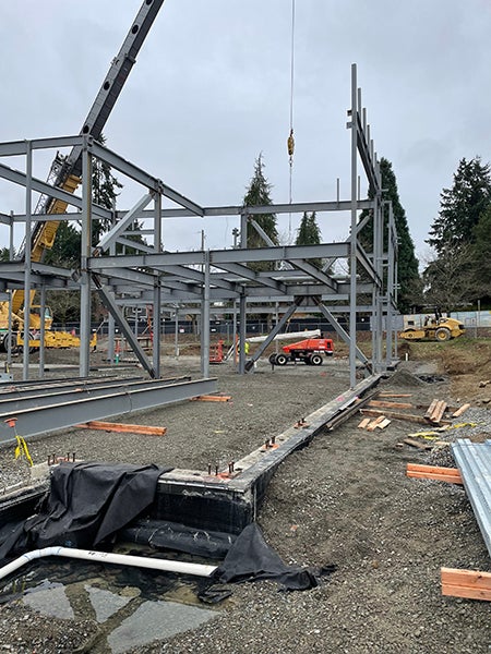 a crane lifts structural steel into place