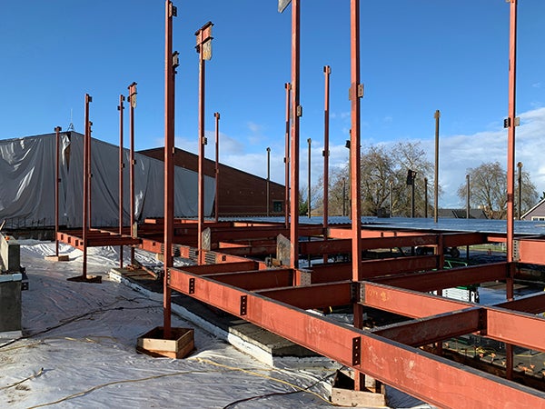 orange steel girders and uprights beginning to form a building