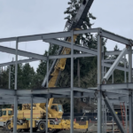 a steel building frame is being erected