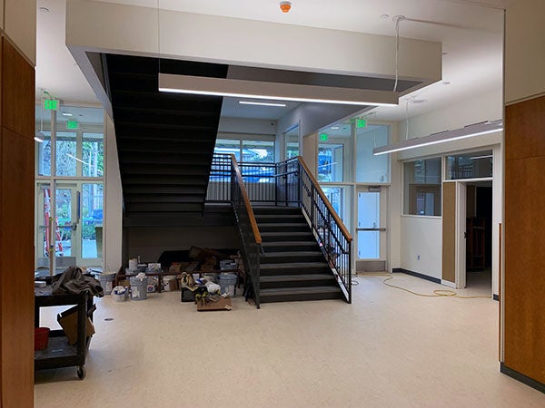 a hallway with a stairway in the middle