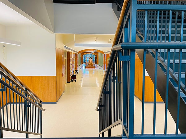 view from the bottom level of a stairway looking out into a hall