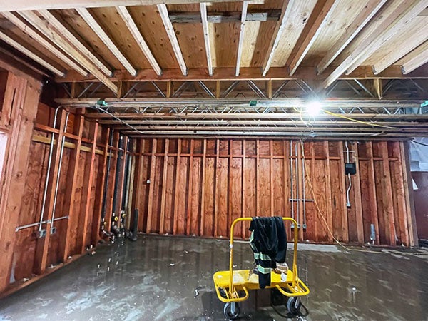 a partially finished interior with wiring runs up the wall studs and across the ceiling joists