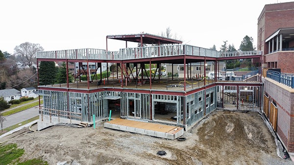a building under construction shows steel wall supports within a structural steel frame