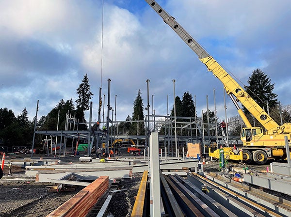 a crane lifts structural steel into place