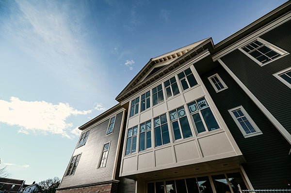 looking up at a 3-story building with a bump out between two sides