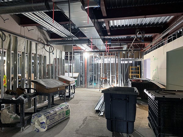 interior of a building under constuction with wall framing and mechanical runs