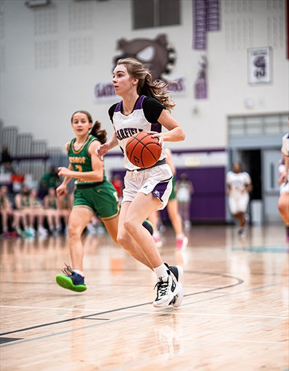 Two basketball players on the court during a game