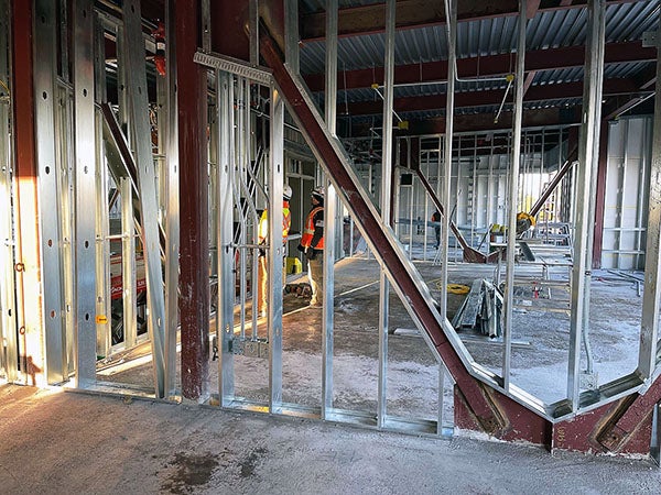 interior of a building under construction with steel stud framing and steel brace frames