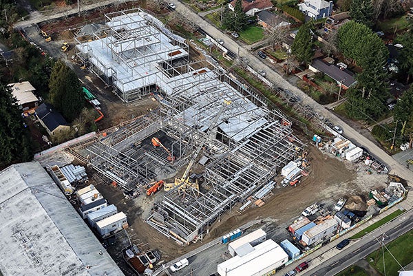 aerial view of a construciton site with a crane and steel framing
