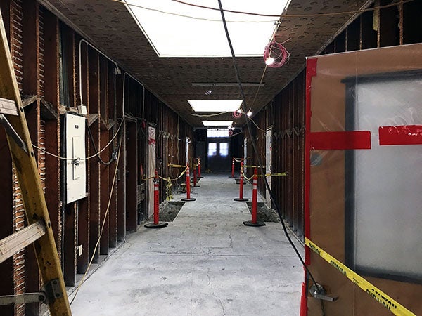 a corridor with skylights and walls stripped to the studs