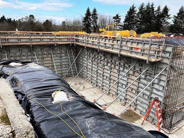 a large pit has metal forms holding up the sides with metal supports bracing them