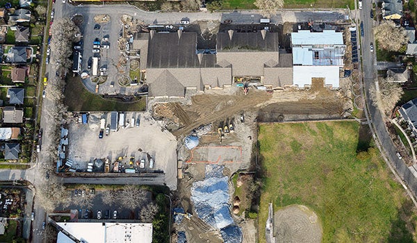 aerial photo of a large building with construction happening at one end