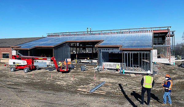 a building under construction with a lift truck