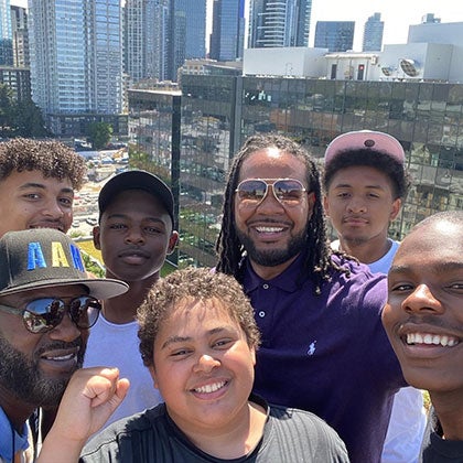 A group of student and adults smile for a photo