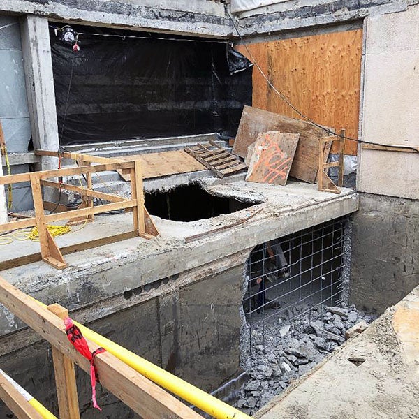 a concrete platform and wall are being demolished