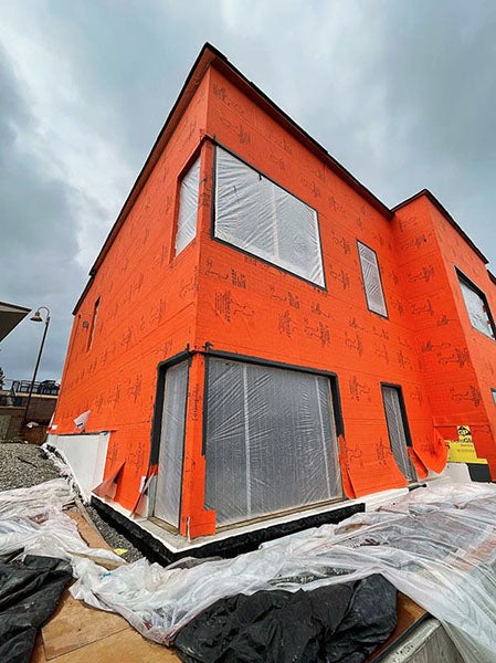 a corner of a building covered in orange material