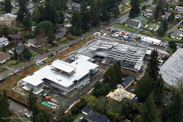 aerial view with a building that has metal roofing on top of steel structure and another building that is just steel structure