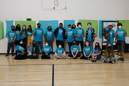A group photo of the club in the school gym