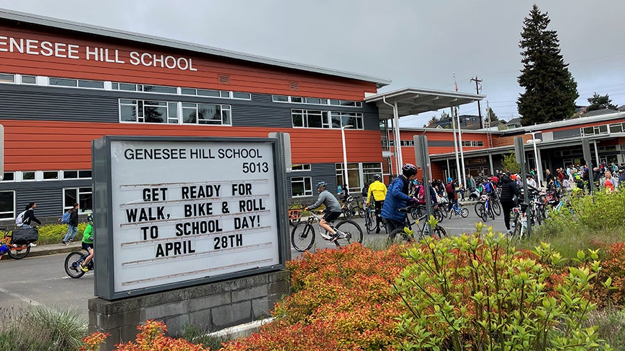 The front of the school building with sign with text "May is Bike Everywhere Month"