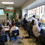 Students in Sam Egelhoff's fifth grade class at Thurgood Marshall meet in enrichment clusters around the classroom
