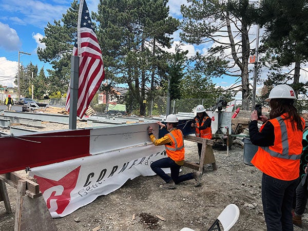 a red and white I beam is being signed