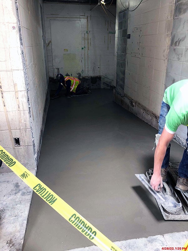 a worker is finishing concrete