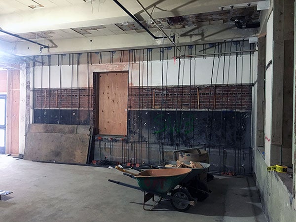 inside of a building under construction with wheelbarrows