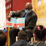 Superintendent Jones reads a book to a classroom of elementary students