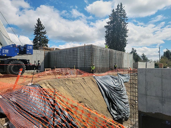 a concrete retaining wall aboe a steep drop off