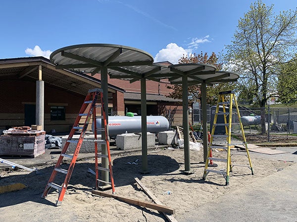 a construction area with a metal shelter made of steel in progress