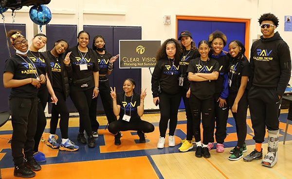 Black Student Union organizers pose for a group picture at Rainier Beach High School's Black Excellence Fair, inside the school's gym