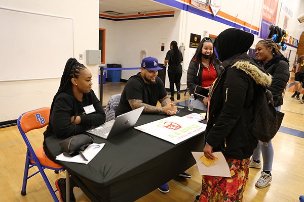Students at Rainier Beach High School's Black Excellence Fair meet with local business owners