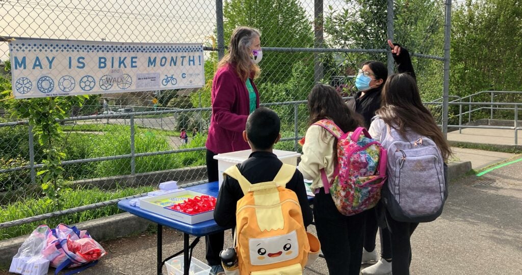 Teacher at Concord Elementary handing out giveaways for walk and bike month