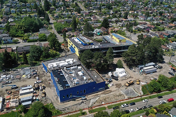 two buildings under construction are joined in the middle