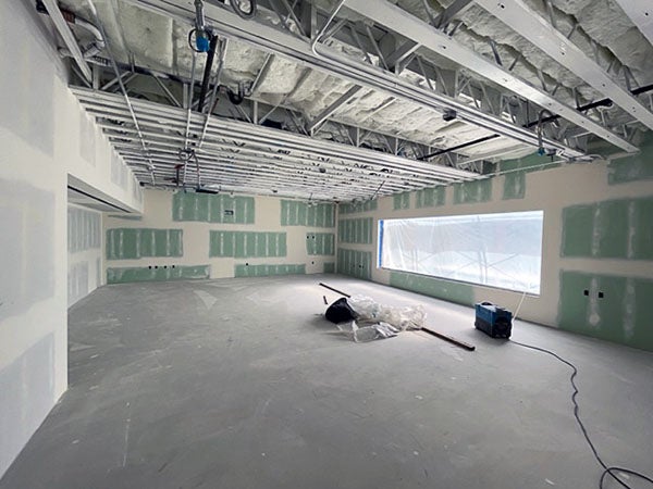 a large room with unpainted drywall