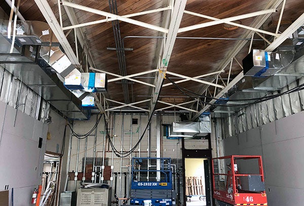 duct work in the ceiling of a large room under construction