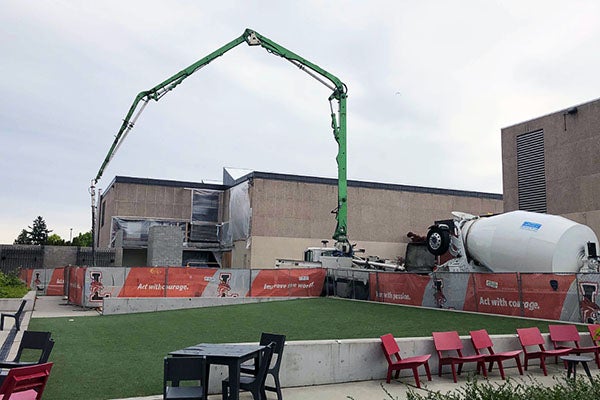 a concrete truck is pumping concrete