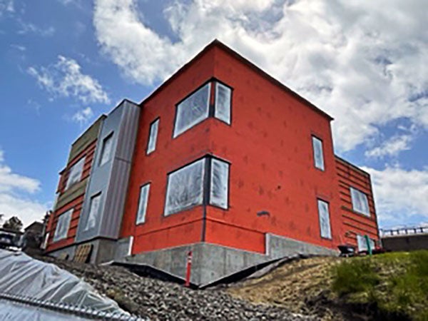 a 2 story building on a hill. it's orange