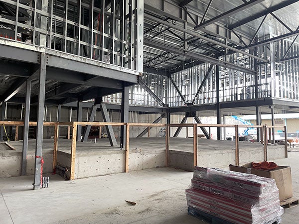 a raised platform below steel framed walls