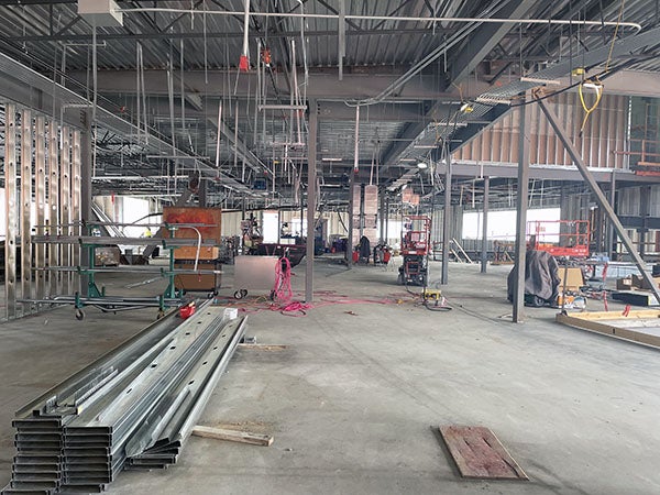 a large space under construction with some steel frames for walls