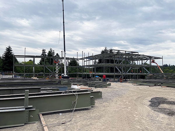 steel beams in front of a steel frame going up