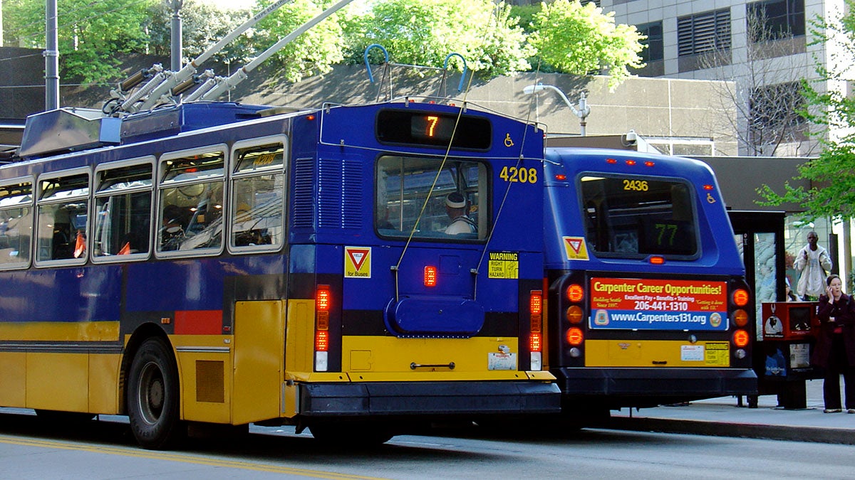 Two metro buses on the city street.