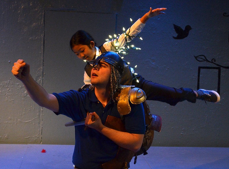 STAGE ACT: Child wrapped in fairy lights, balancing on an Adults shoulders 