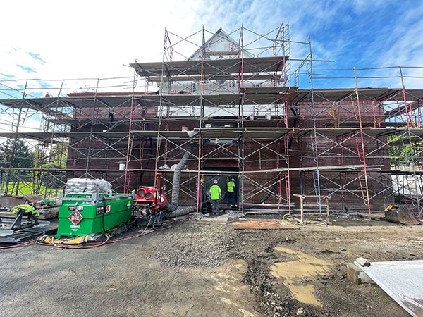 a brick building with scaffolding and construction materials