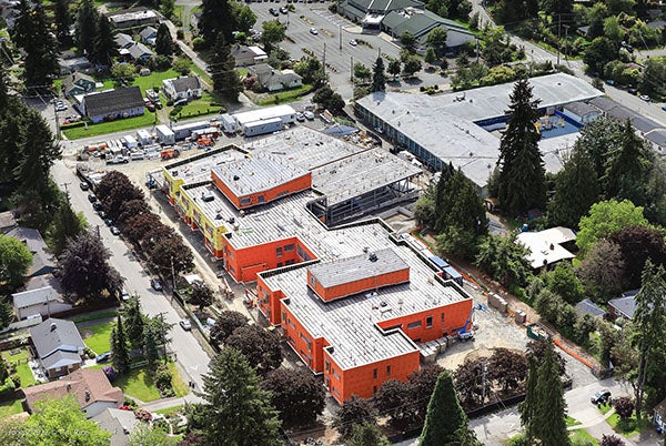 aerial photo of a large building with houses and trees